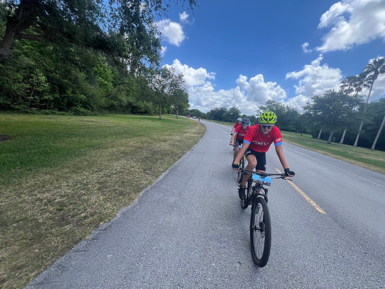 Olen Lokkesmoe on a road cycling training ride on a park road in red DNV cycling kit
